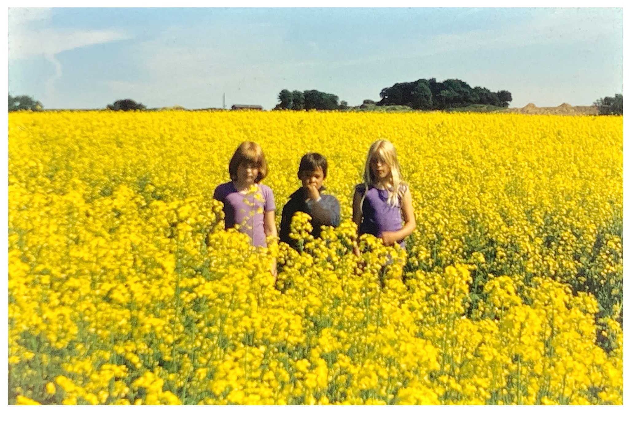 Michael Baastrup Chang at age five with two friends in a yellow rapeseed field in the summer of 1979
