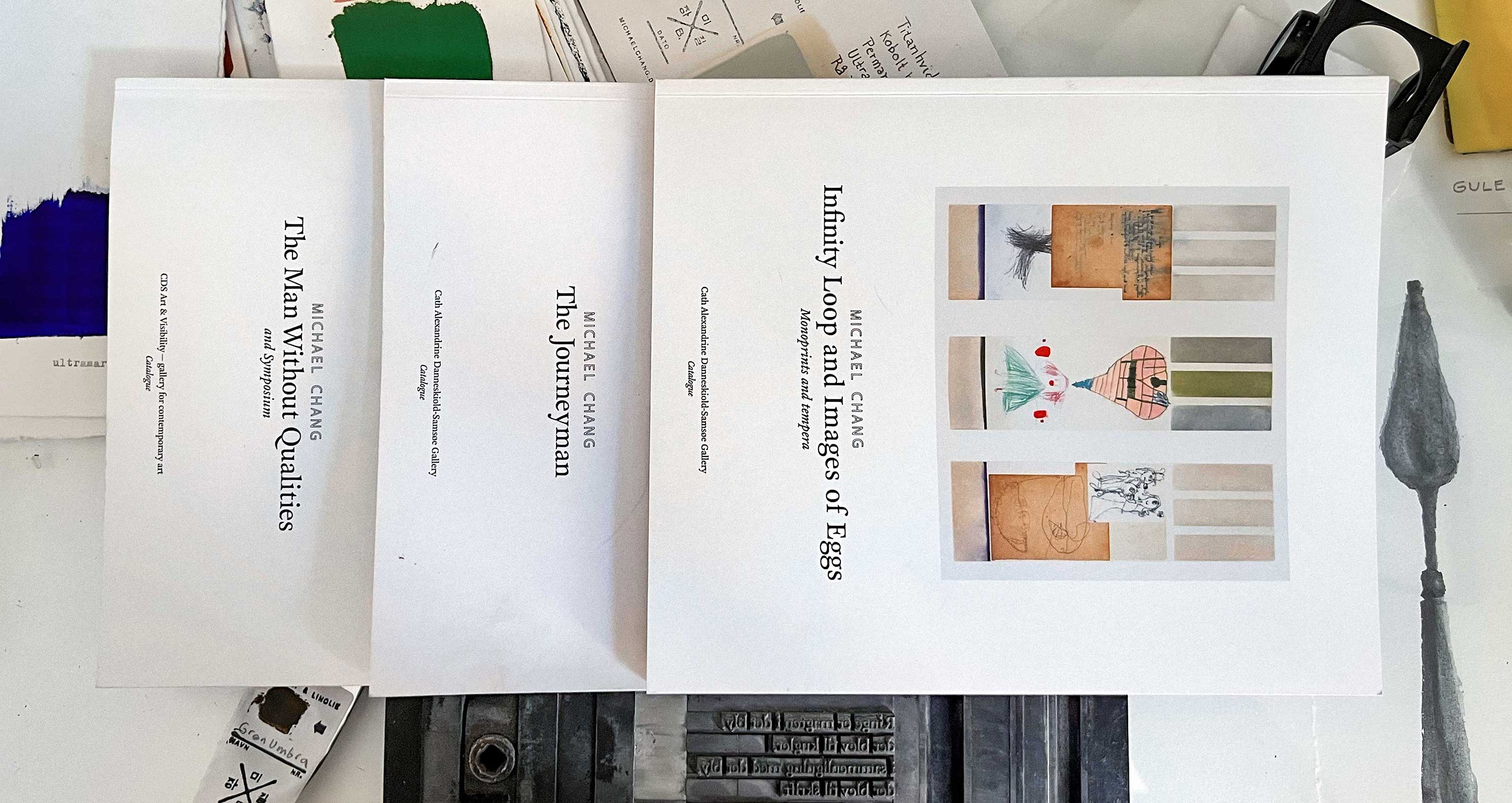 Workdesk with the three catalogues from Michael Baastrup Chang's solo exhibitions in 2010, 2011 and 2012.