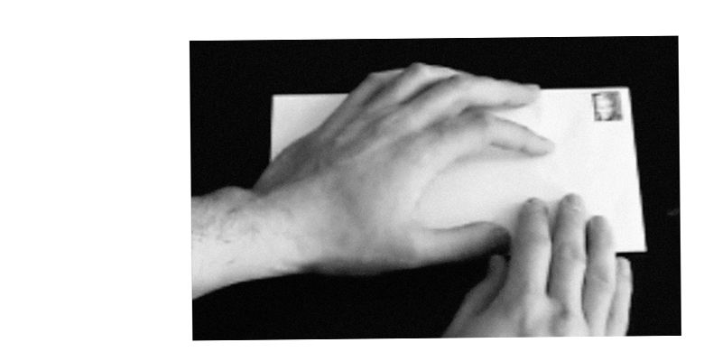 Video still from Interfaces showing a blank envelope bearing a Danish postage stamp depicting Queen Margrethe II
